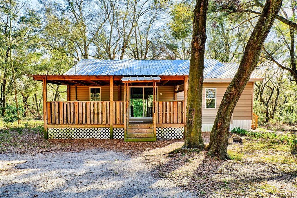 300 South Us Highway Bell, FL 32619 - Photo 2 of 47 a porch with a bench next to a yard