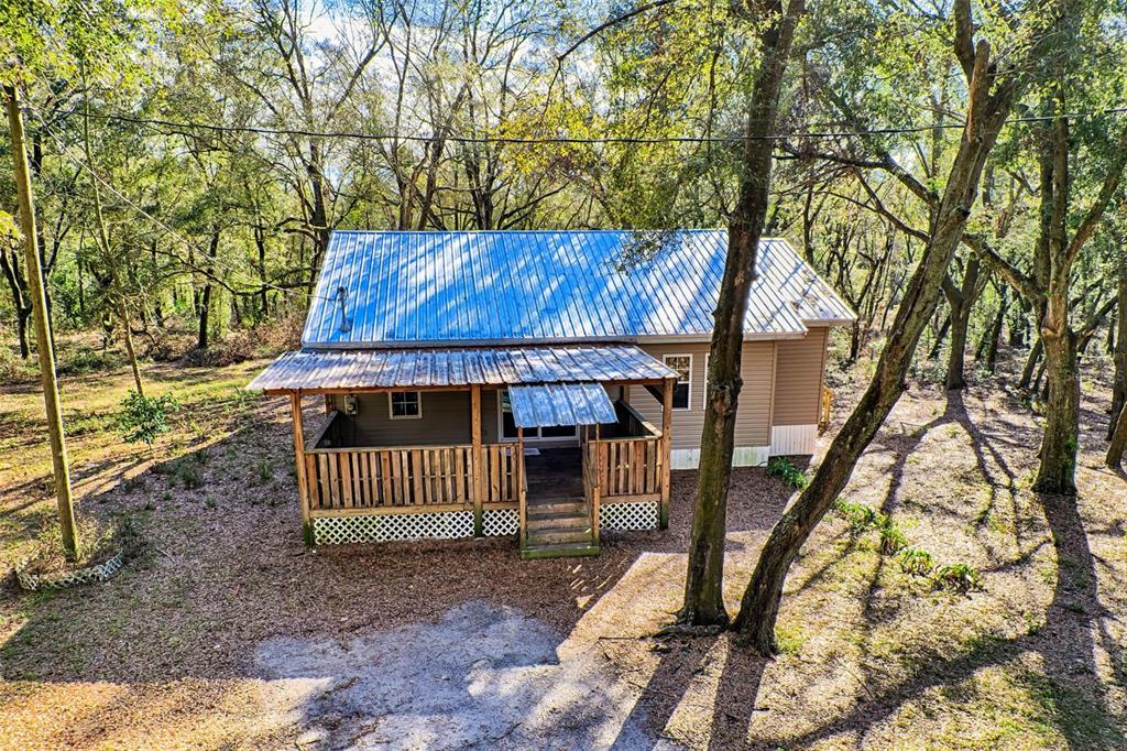 300 South Us Highway Bell, FL 32619 - Photo 31 of 47 a view of a small house with a tree back yard