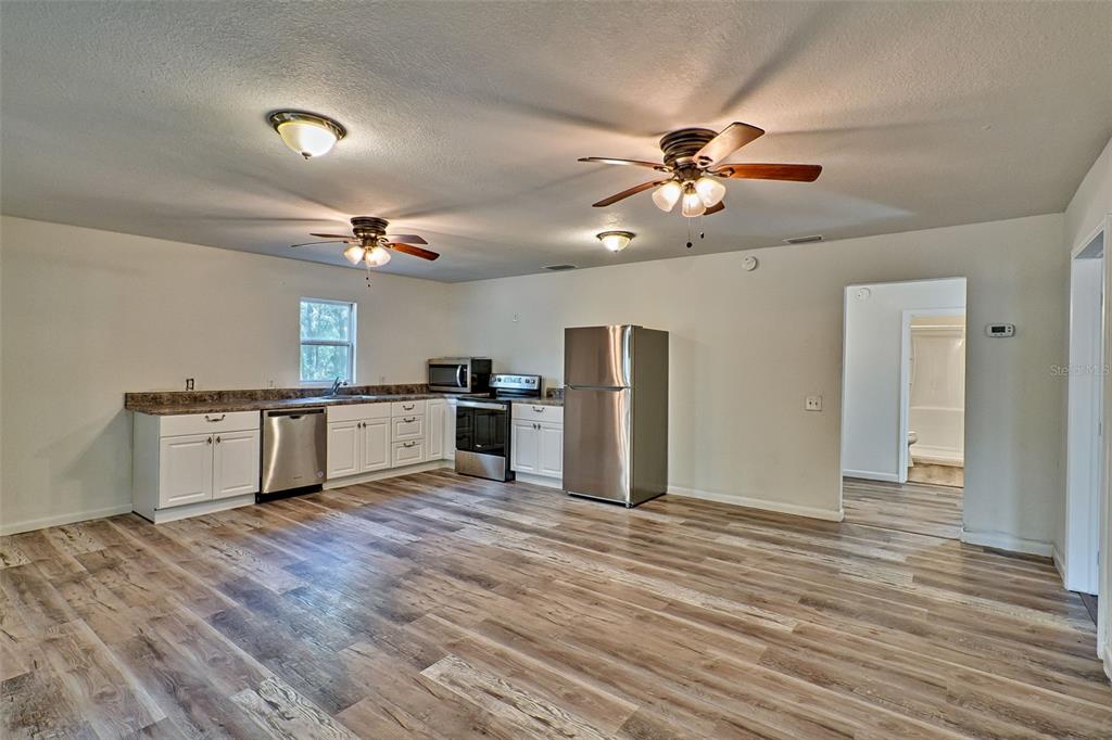 300 South Us Highway Bell, FL 32619 - Photo 6 of 47 a large kitchen with stainless steel appliances granite countertop a stove and a refrigerator