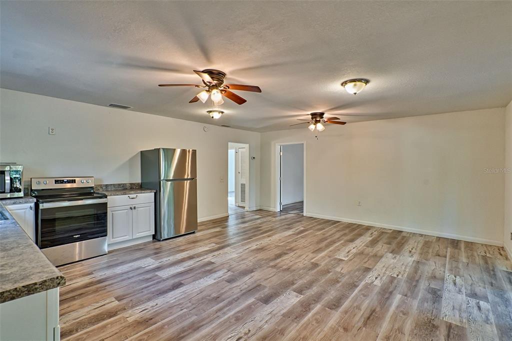 300 South Us Highway Bell, FL 32619 - Photo 7 of 47 wooden floor in an empty room with a kitchen