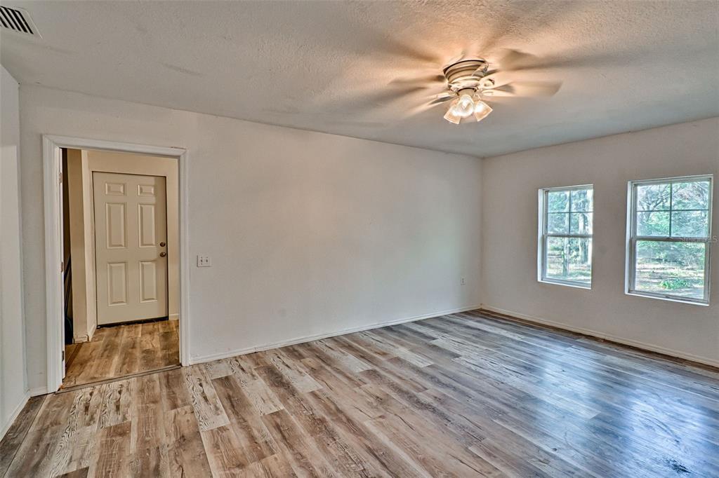 300 South Us Highway Bell, FL 32619 - Photo 10 of 47 a view of an empty room with a window and wooden floor