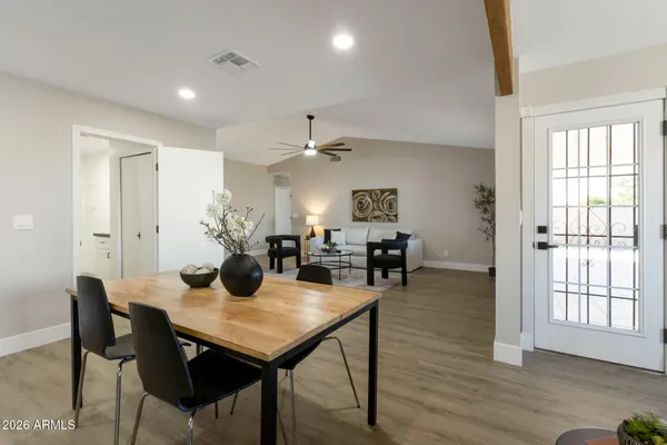 a view of a dining room with furniture and wooden floor