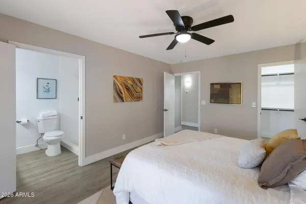 a bedroom with a bed and a ceiling fan
