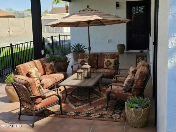 a outdoor living space with furniture and umbrella