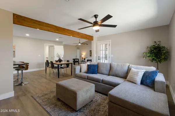 a living room with furniture and a chandelier