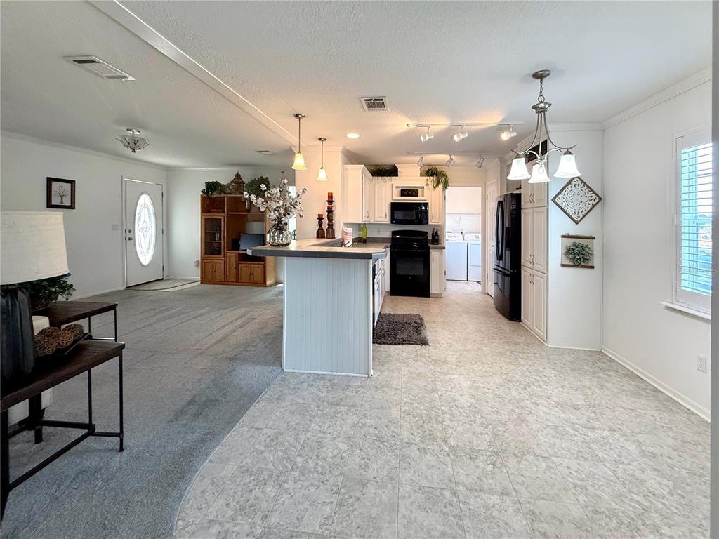 101 St Johns Way West Apollo Beach, FL 33572 - Photo 5 of 24 a view of a kitchen and dining table chairs