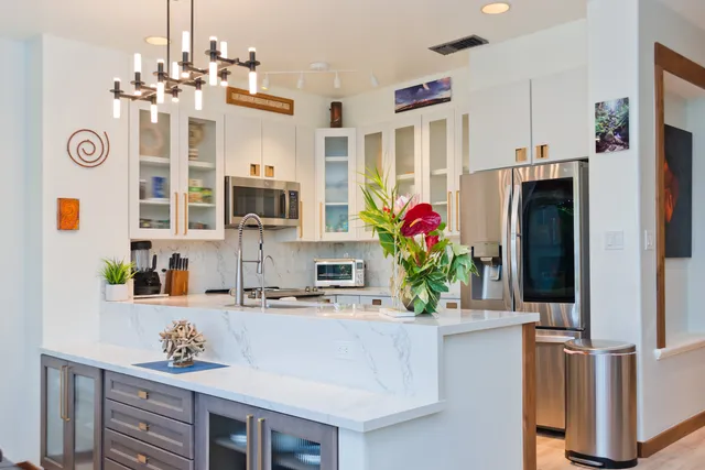 a kitchen with stainless steel appliances granite countertop a refrigerator and a sink
