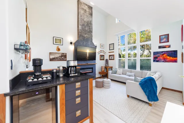 a kitchen with stainless steel appliances granite countertop a stove a sink dishwasher and a microwave with wooden floor