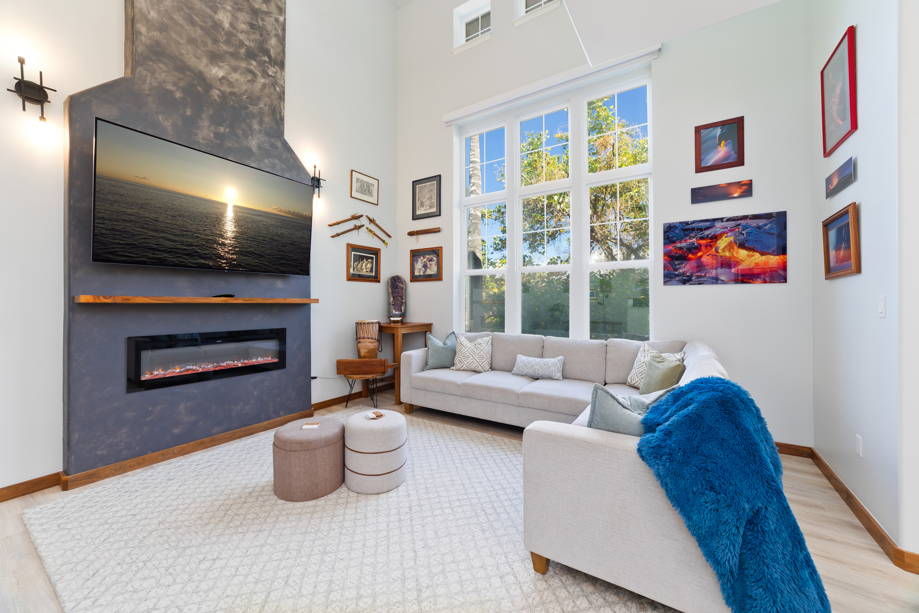 69-555 Waikoloa Beach Drive, Unit 2303 Waikoloa, HI 96738 - Photo 14 of 30 a living room with furniture a flat screen tv and a fireplace
