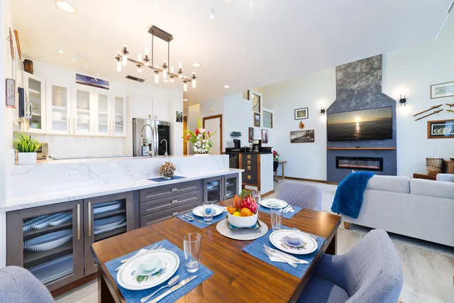 a view of a dining room with furniture and a chandelier