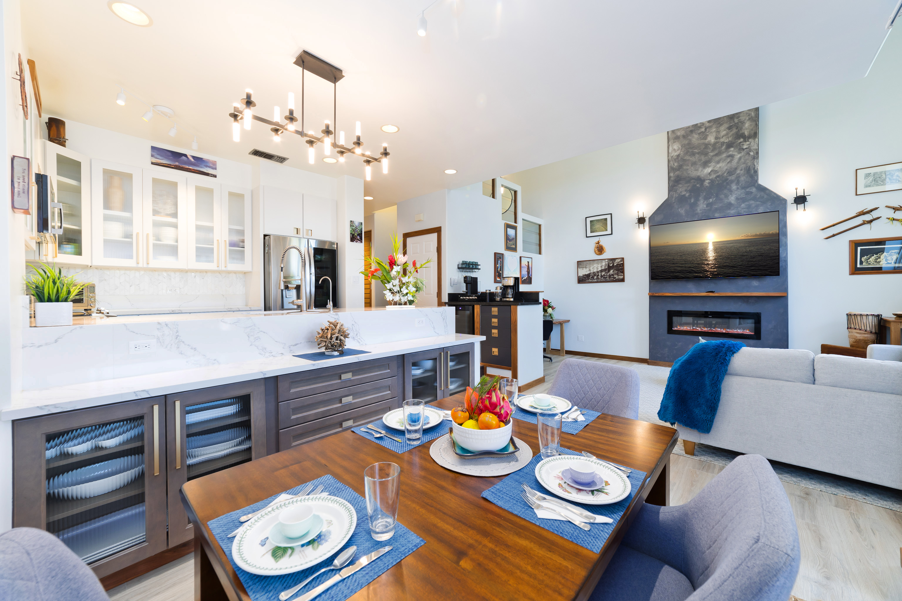 69-555 Waikoloa Beach Drive, Unit 2303 Waikoloa, HI 96738 - Photo 16 of 30 a view of a dining room with furniture and a chandelier