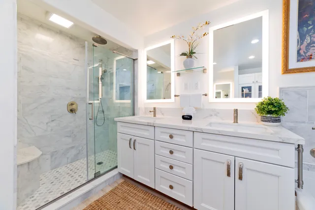 a spacious bathroom with double sink and shower