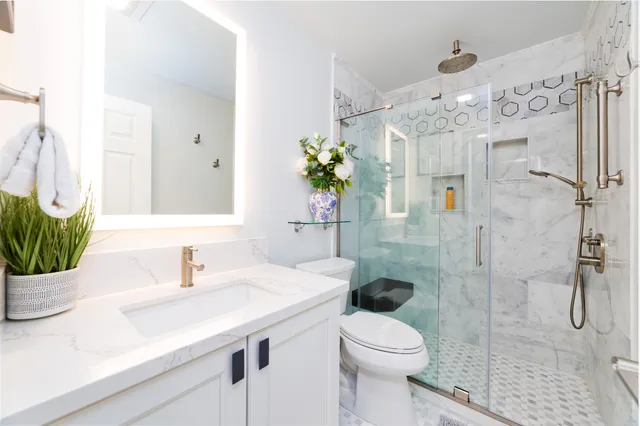 a bathroom with a sink toilet and shower
