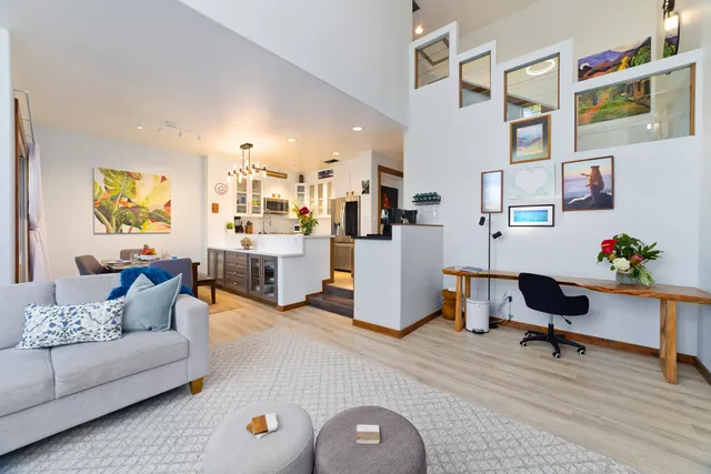 a living room with furniture and a workspace