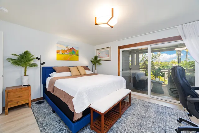 a bedroom with a bed and potted plant with the outer view