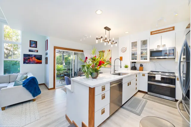 a kitchen with stainless steel appliances granite countertop a sink and a stove