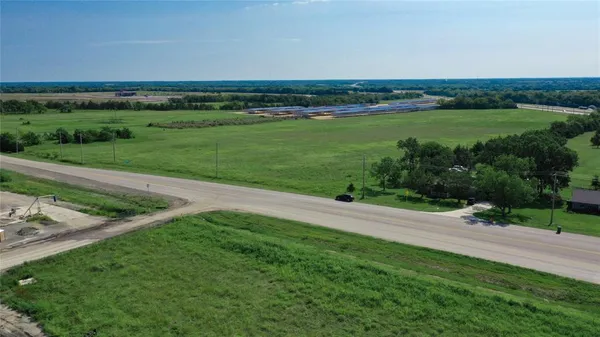 a view of a field with an ocean view