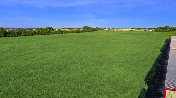 a view of a green field with clear sky