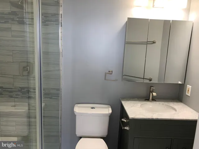 a bathroom with a toilet sink and shower