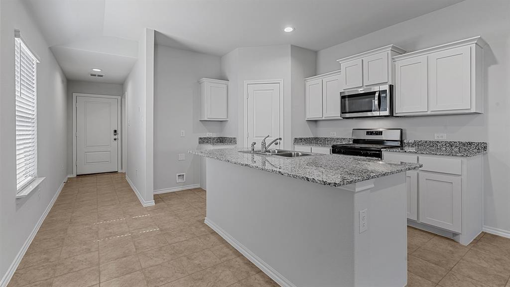 180 Mojave Road Boyd, TX 76023 - Photo 36 of 38 a kitchen with stainless steel appliances granite countertop a sink stove and refrigerator