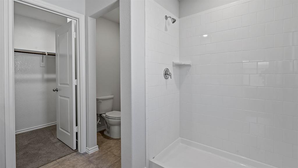 180 Mojave Road Boyd, TX 76023 - Photo 20 of 38 a bathroom with a granite countertop toilet and a shower