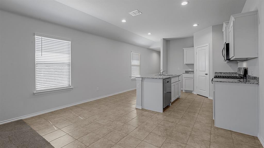 180 Mojave Road Boyd, TX 76023 - Photo 5 of 38 a open kitchen with white cabinets and a refrigerator