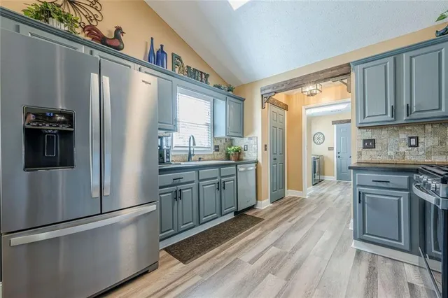 a view of a dining room with furniture a chandelier and wooden floor