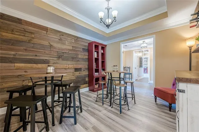 a bedroom with a bed a window and a chandelier