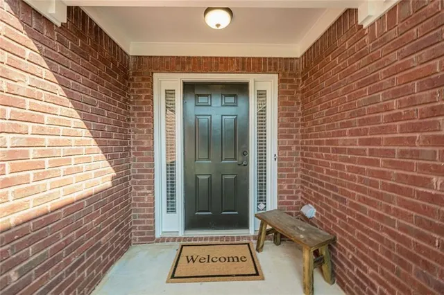 a view of a door with wooden floor and a potted plant