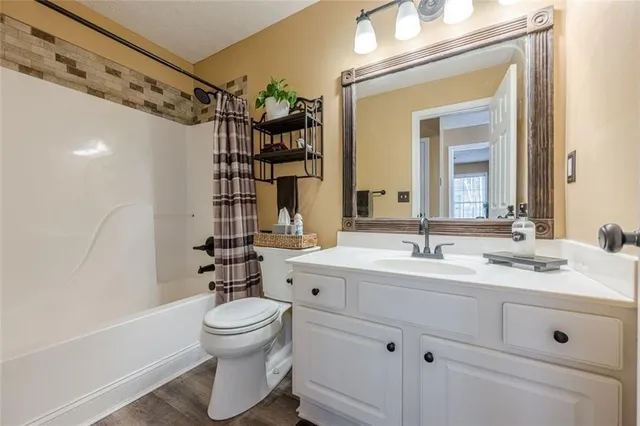 a backyard of a house with table chairs and wooden fence