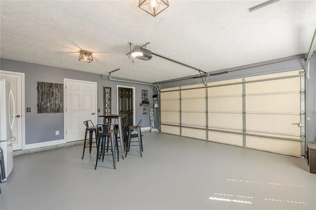 a view of backyard with large trees and wooden fence