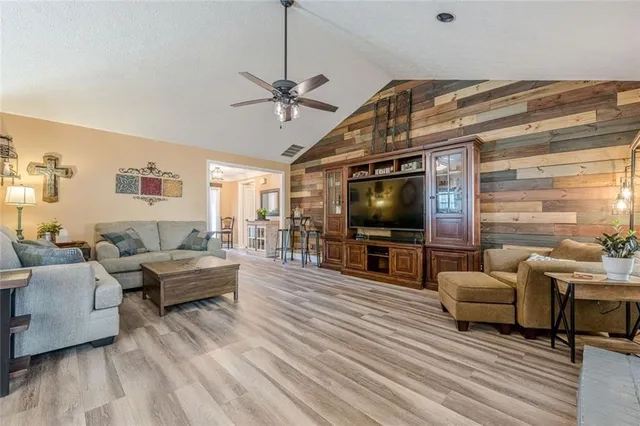 a living room with fireplace furniture and a wooden floor