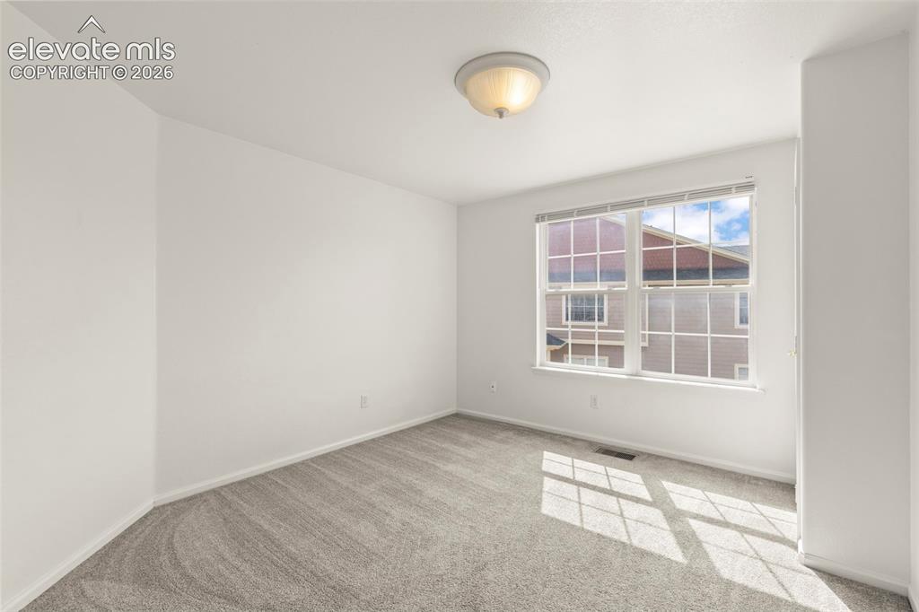 1563 Monterey Road, Unit D Colorado Springs, CO 80910 - Photo 12 of 22 an empty room with a window