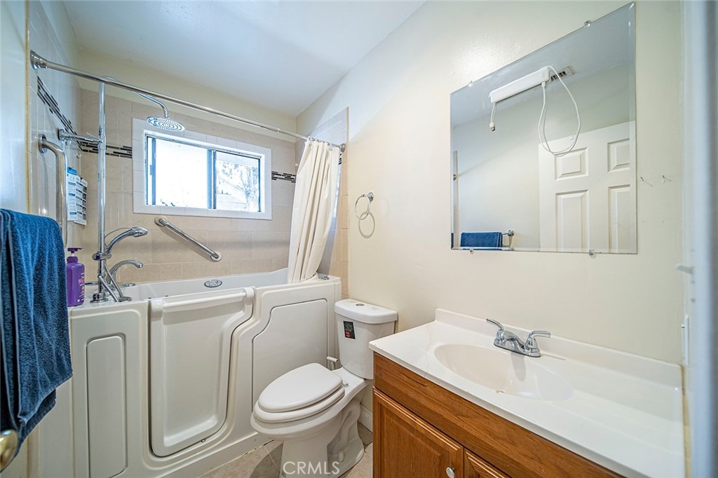 1016 Vina Avenue Long Beach, CA 90813 - Photo 14 of 22 a bathroom with a sink toilet and shower