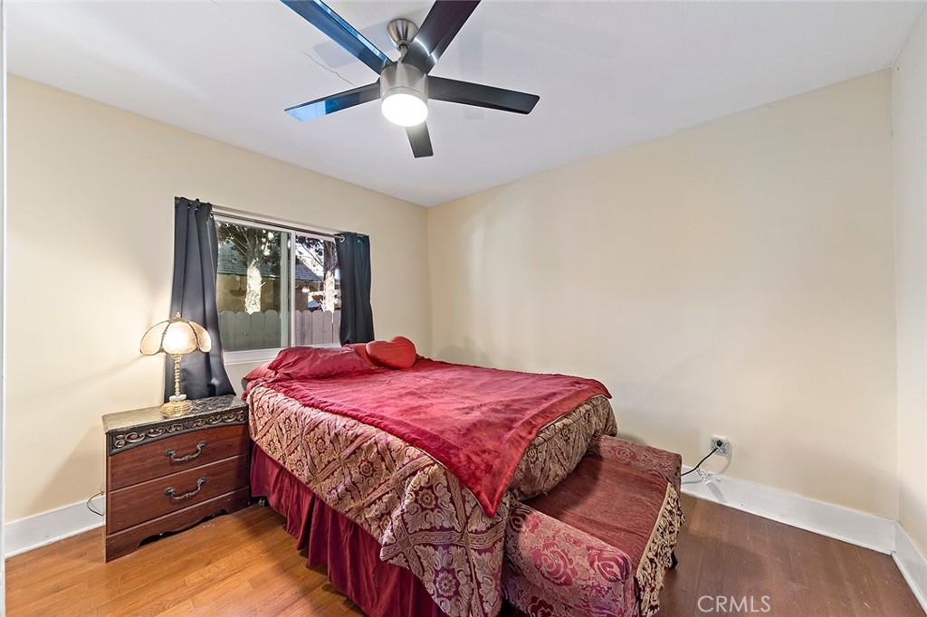 1016 Vina Avenue Long Beach, CA 90813 - Photo 15 of 22 a bedroom with a bed and a chandelier