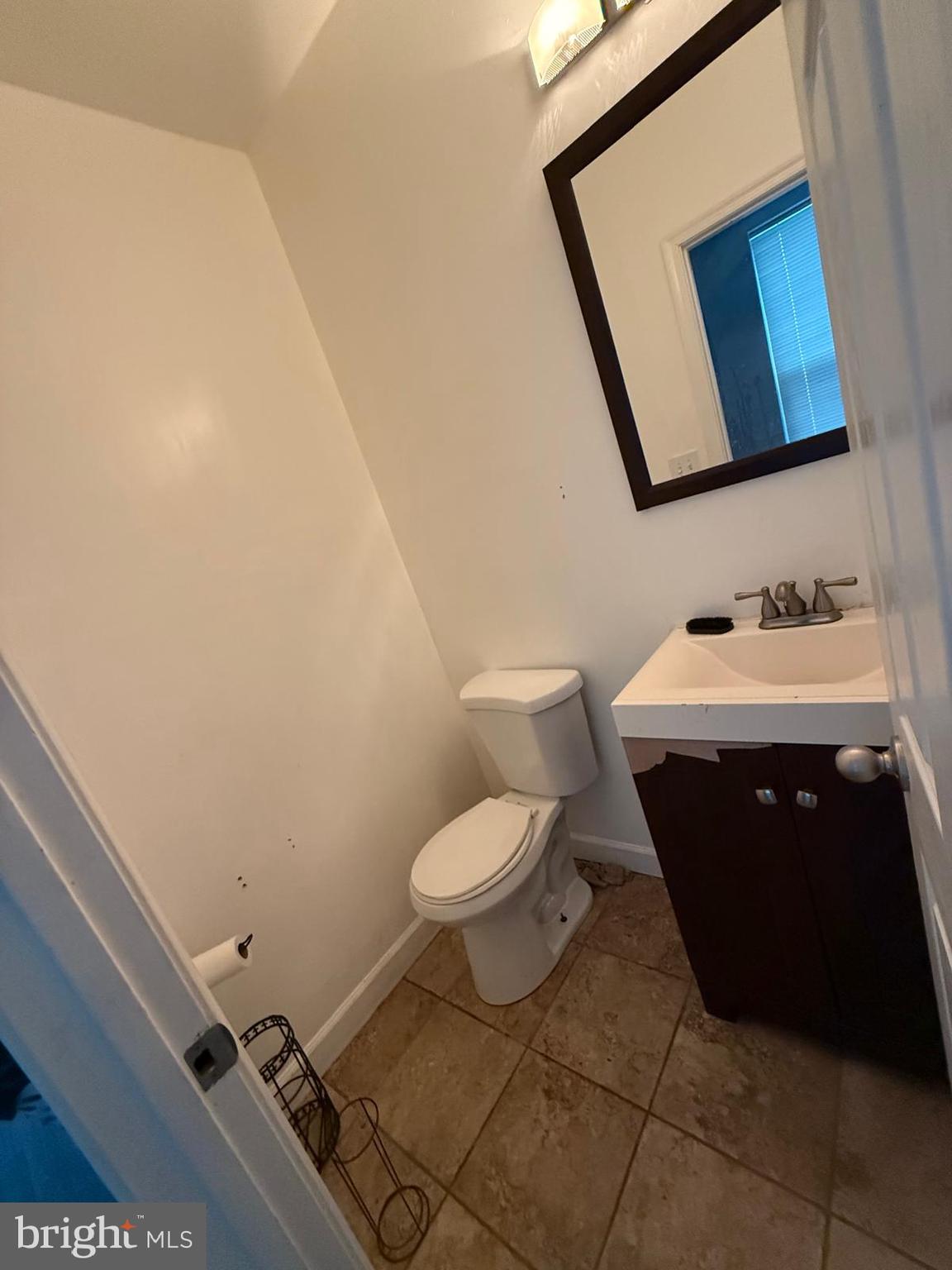 1723 Homestead Street Baltimore, MD 21218 - Photo 5 of 27 a bathroom with a sink toilet and mirror