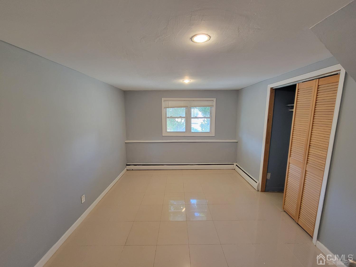 19 Baldwin Road Edison, NJ 08817 - Photo 11 of 36 an empty room with windows and closet