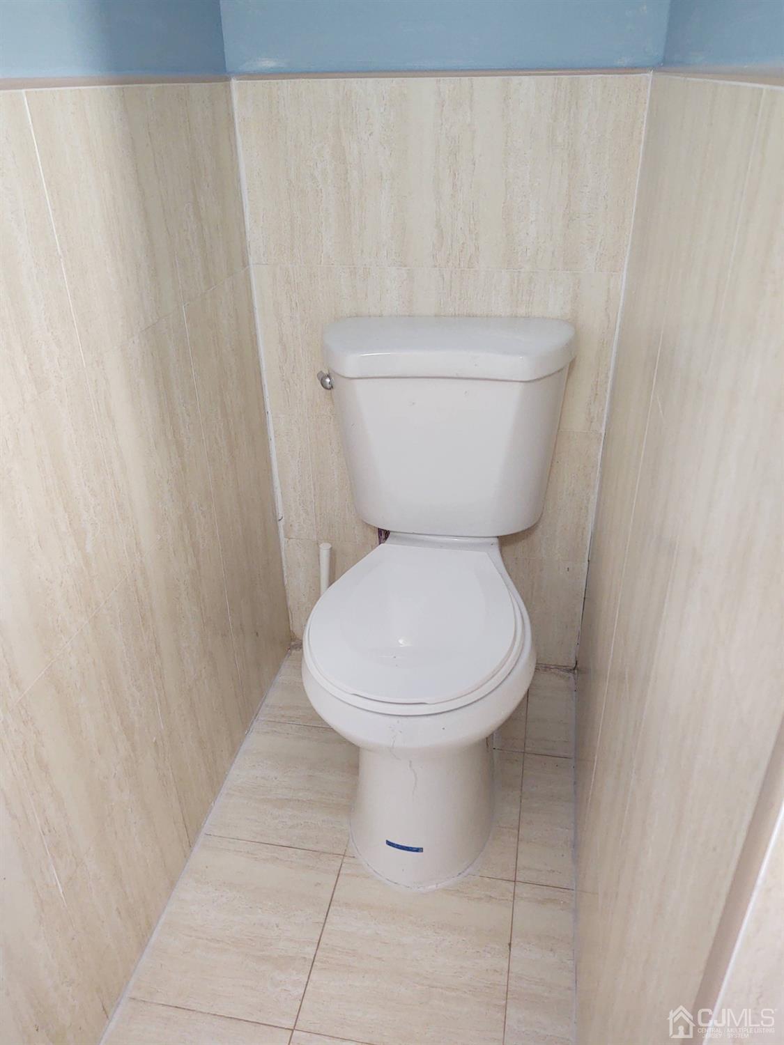 19 Baldwin Road Edison, NJ 08817 - Photo 17 of 36 a bathroom with a toilet and a shower curtain