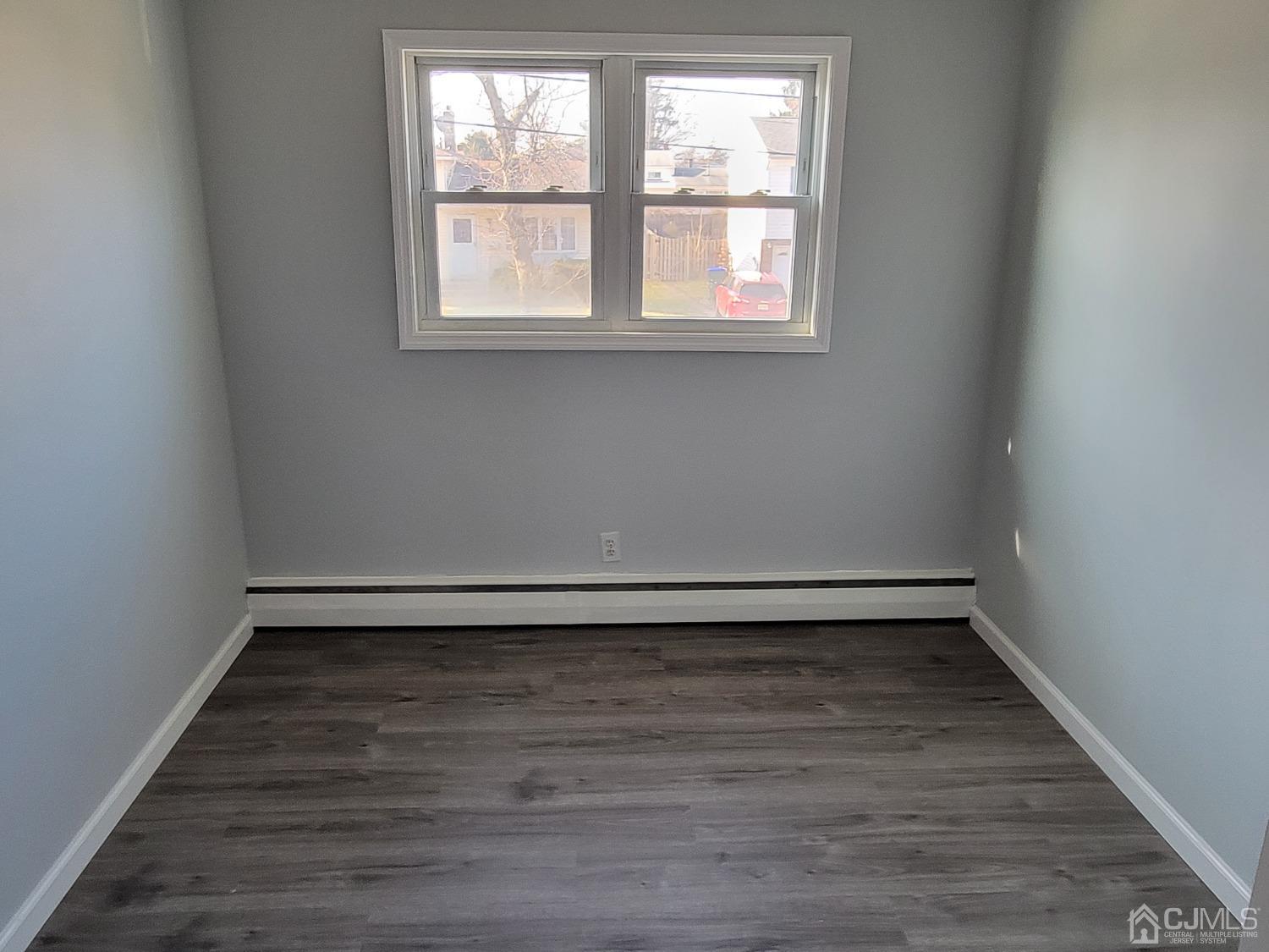 19 Baldwin Road Edison, NJ 08817 - Photo 23 of 36 an empty room with wooden floor and windows