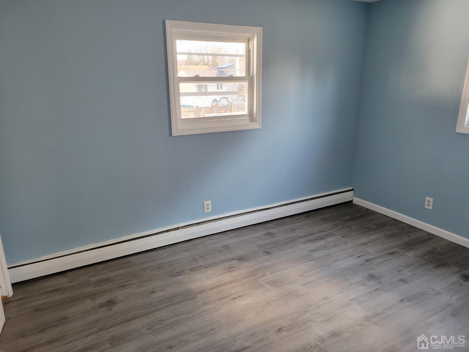 19 Baldwin Road Edison, NJ 08817 - Photo 28 of 36 an empty room with wooden floor and windows