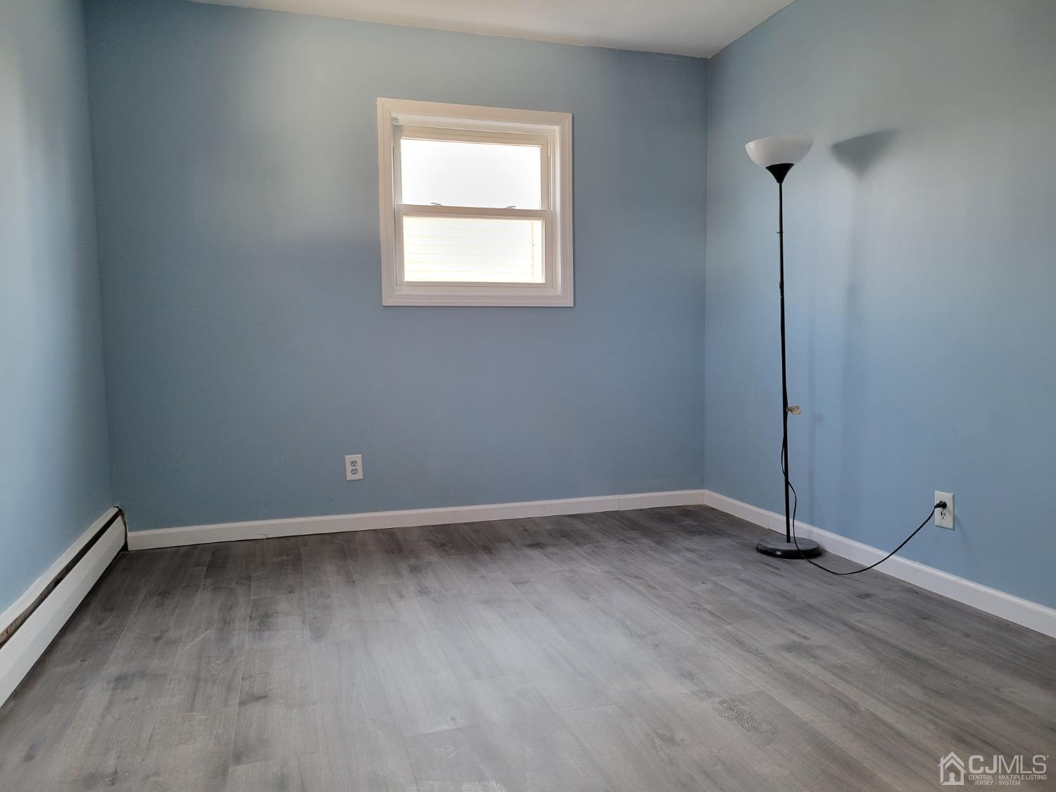 19 Baldwin Road Edison, NJ 08817 - Photo 31 of 36 an empty room with wooden floor and windows
