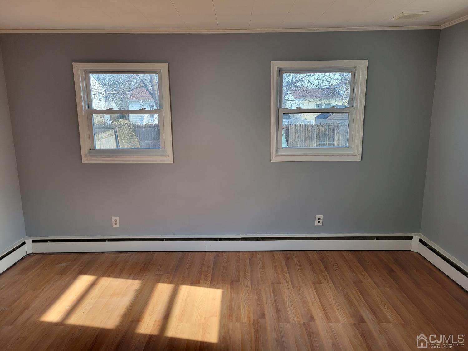 19 Baldwin Road Edison, NJ 08817 - Photo 7 of 36 a view of an empty room with wooden floor and a window