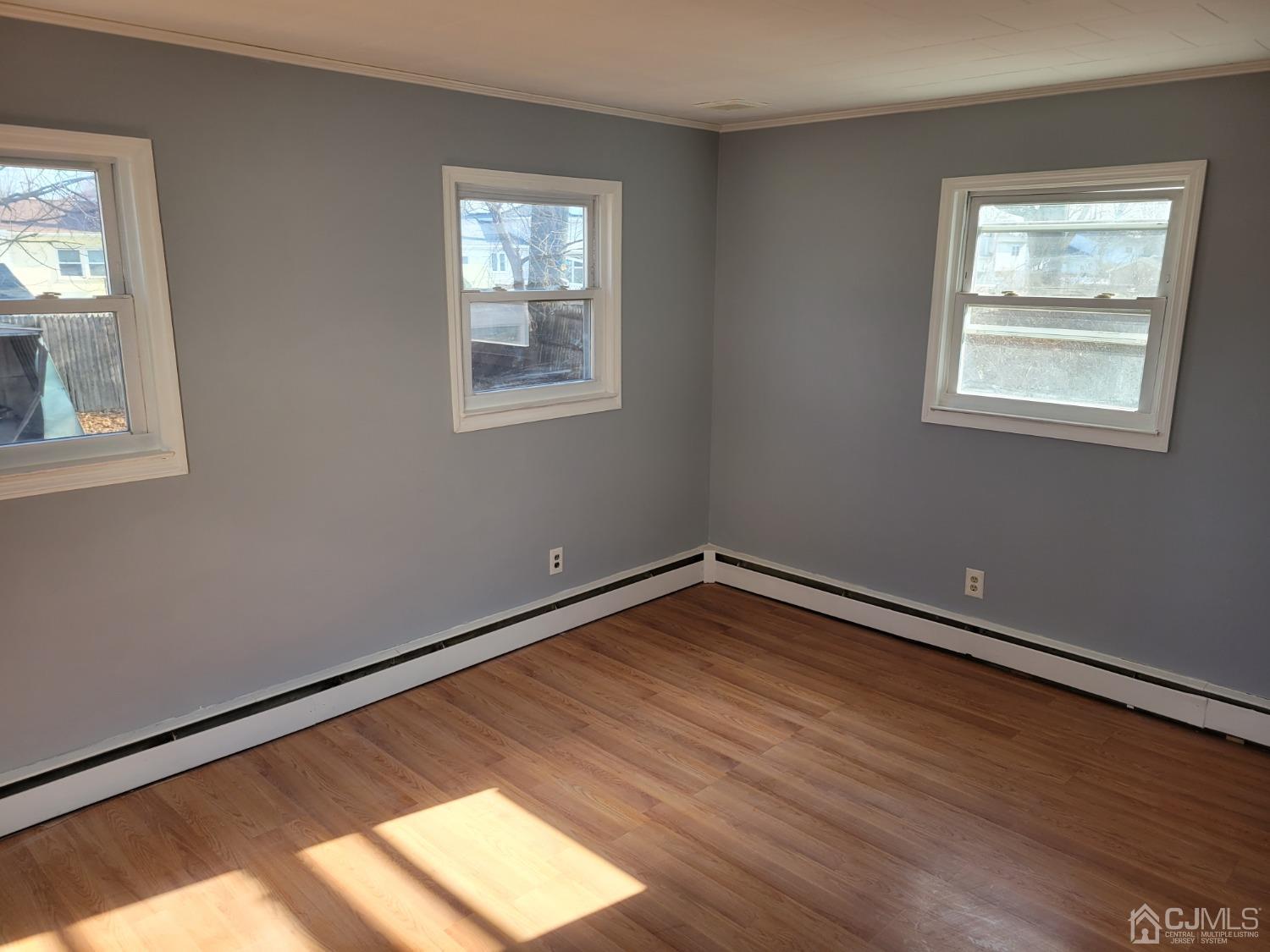 19 Baldwin Road Edison, NJ 08817 - Photo 9 of 36 a view of an empty room with wooden floor and a window