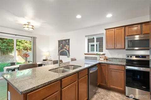 a kitchen with a sink stove and microwave