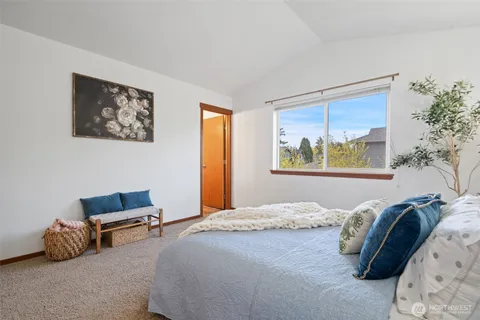 a bedroom with a bed and a painting on the wall