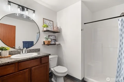 a bathroom with a sink toilet and mirror