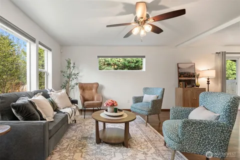 a living room with furniture a rug and a large window