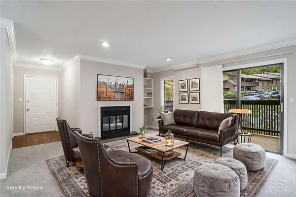 a living room with furniture a fireplace and a floor to ceiling window