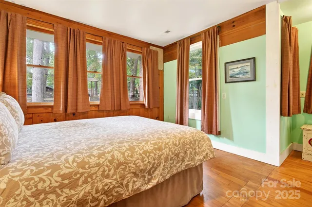 a bedroom with a bed and a large window