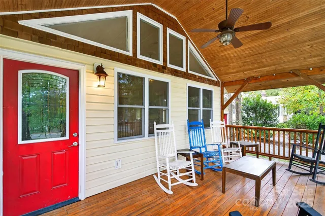 a view of a deck with wooden floor and outdoor seating